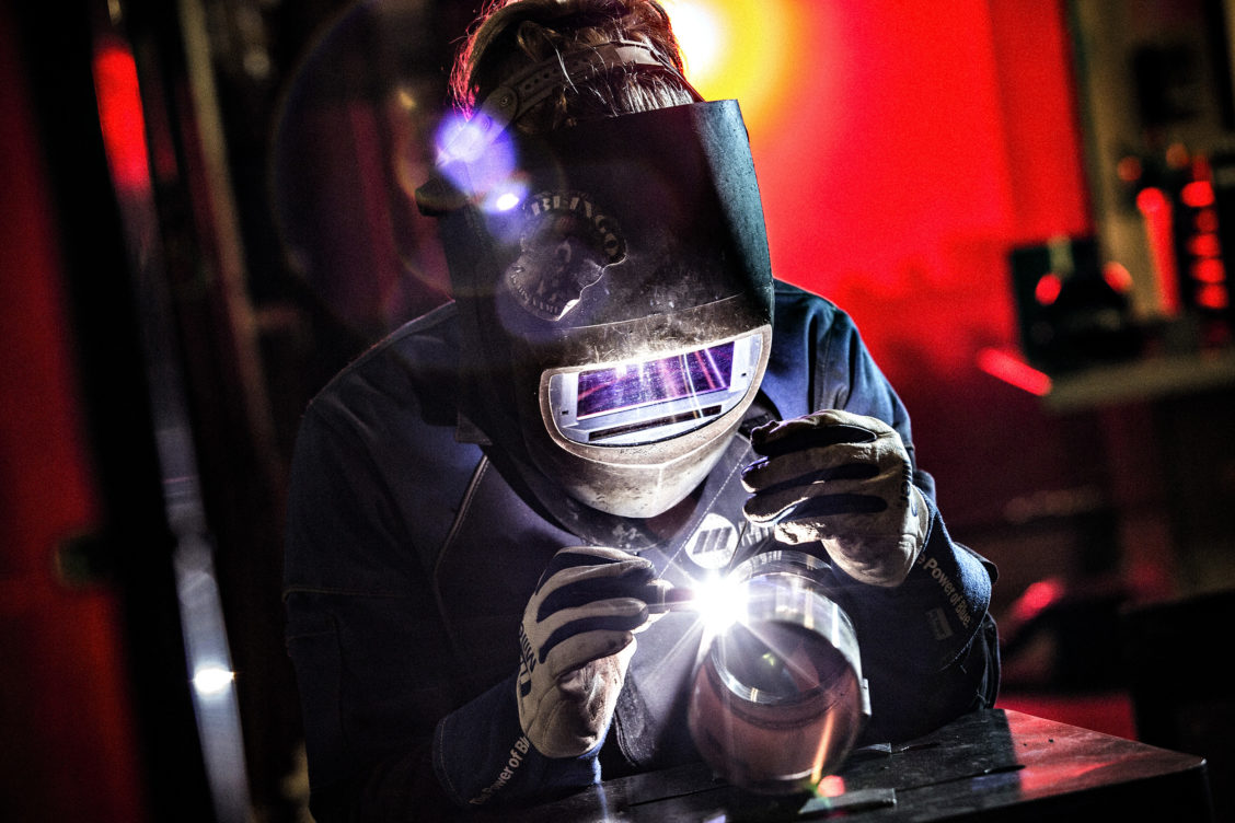 Photograph of a person welding in Miller gear