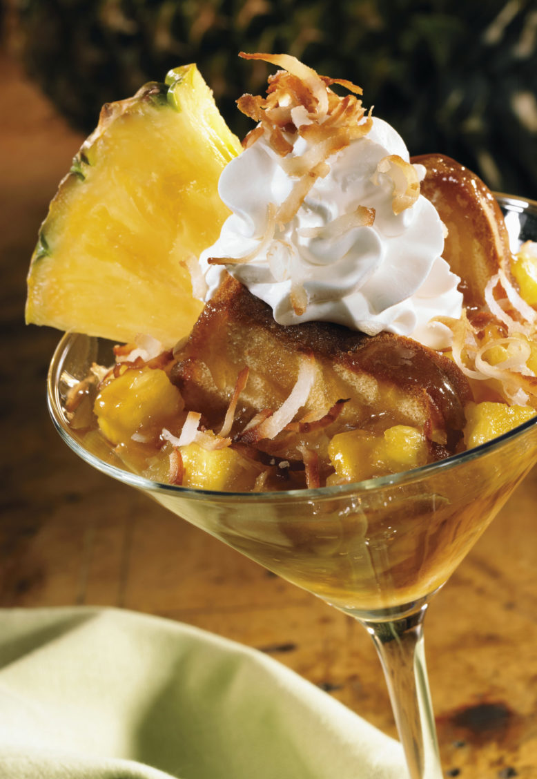 Photograph of a tropical pineapple dessert in a martini glass