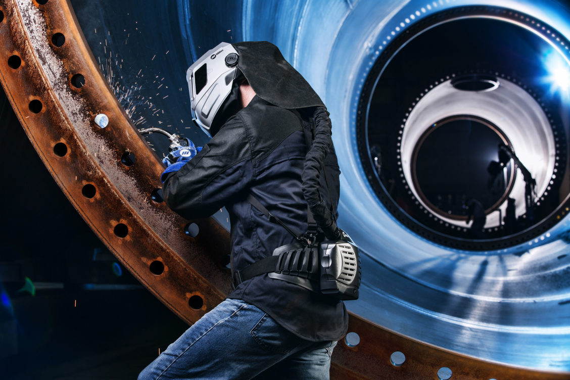 Industrial photography of a man welding in Miller gear