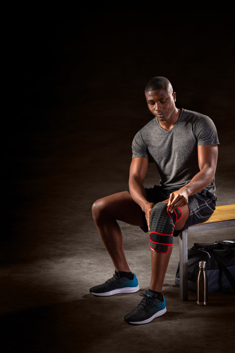 Product photography of an athletic man wearing a knee brace