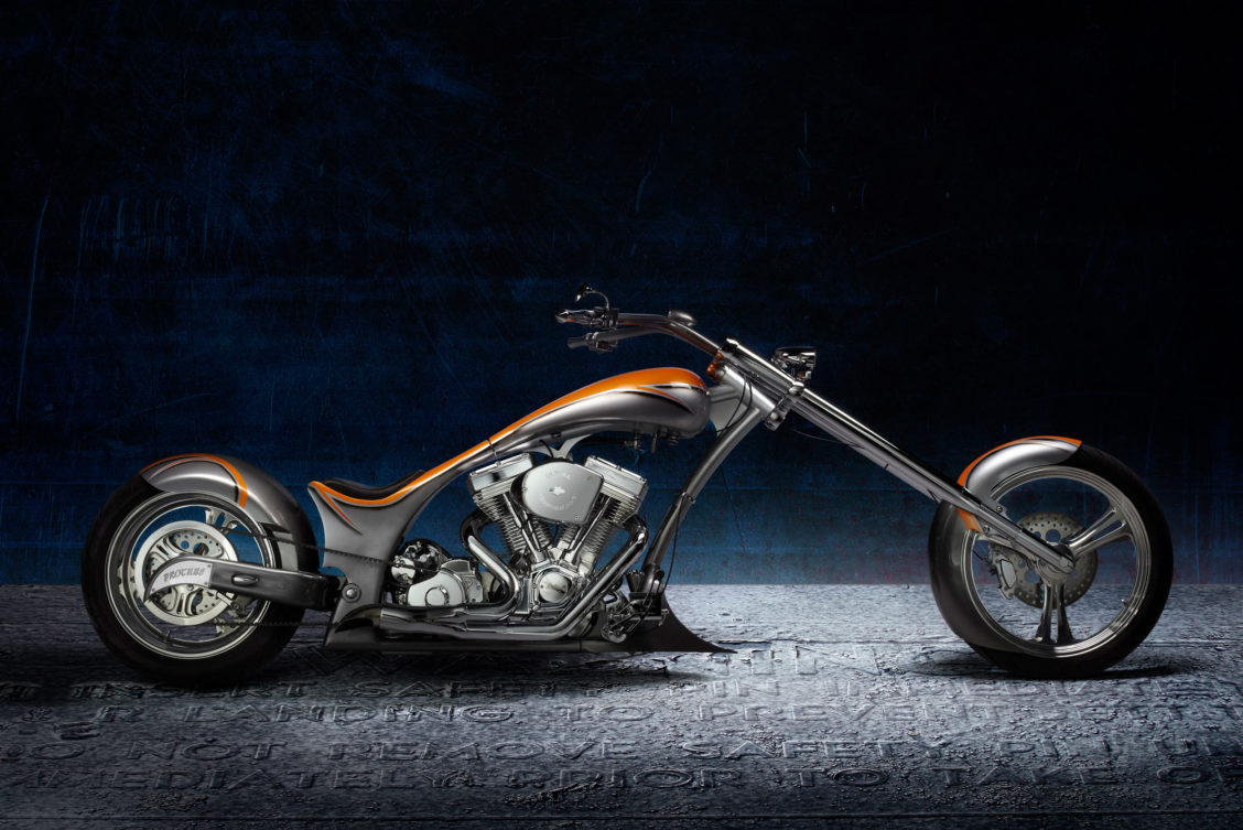 Product photography of an orange accented motorcyle