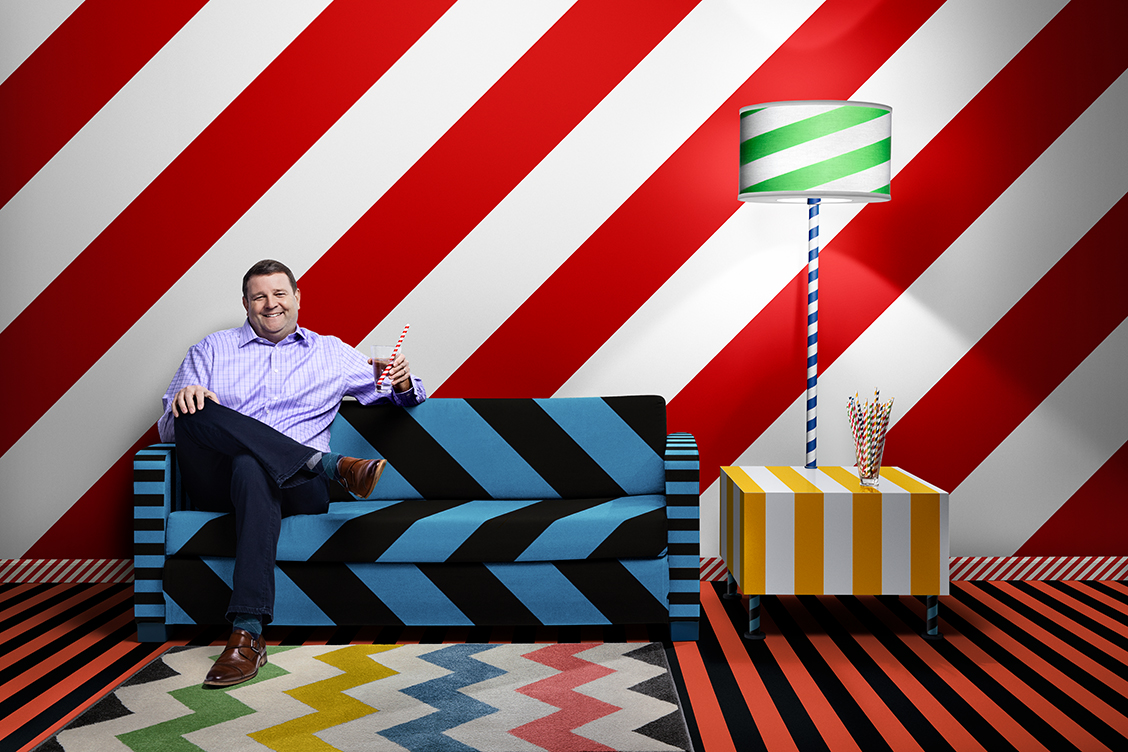 Retouched image of a man on a couch with abstract striped background for Hoffmaster