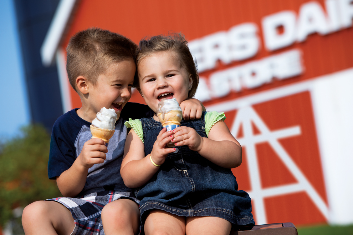 Lifestyle photography of two children with ice cream cones at a dairy store